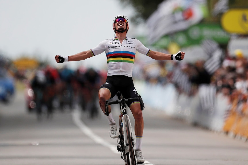 Julian Alaphilippe of France celebrates as he crosses the finish line