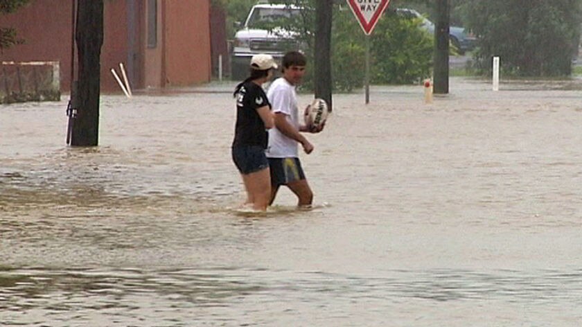 Emergency sirens are sounding in Charleville and business owners are sandbagging their shops.