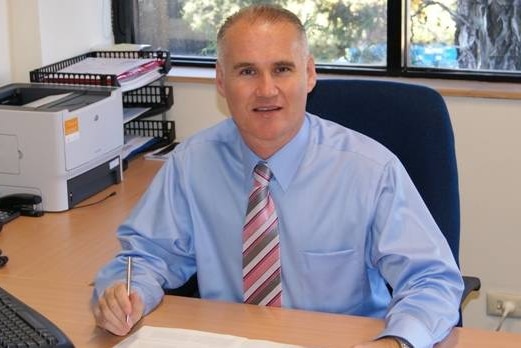 Scott Williams sits at a desk.