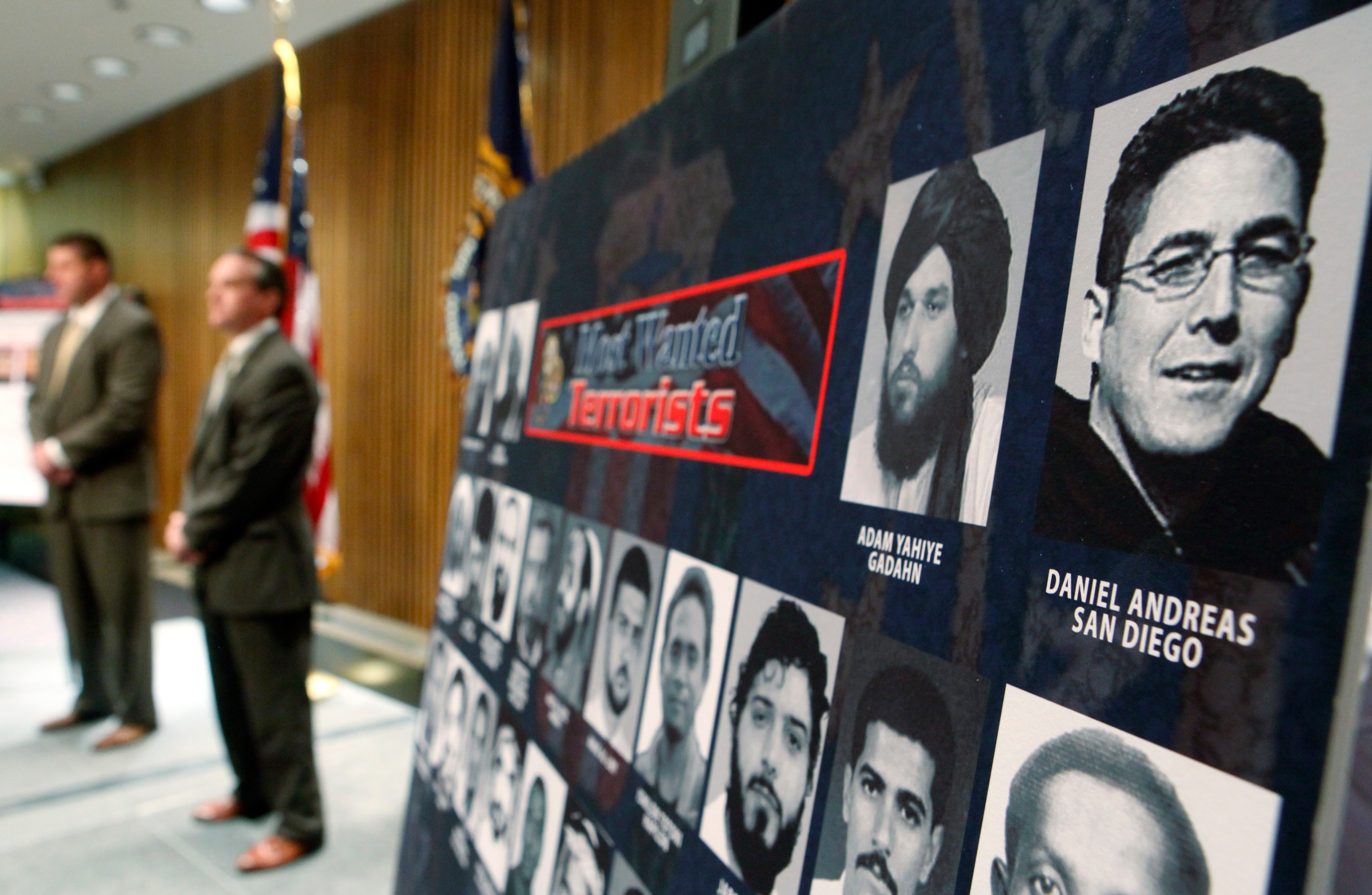 A poster shows mens faces that are on the FBI most wanted list