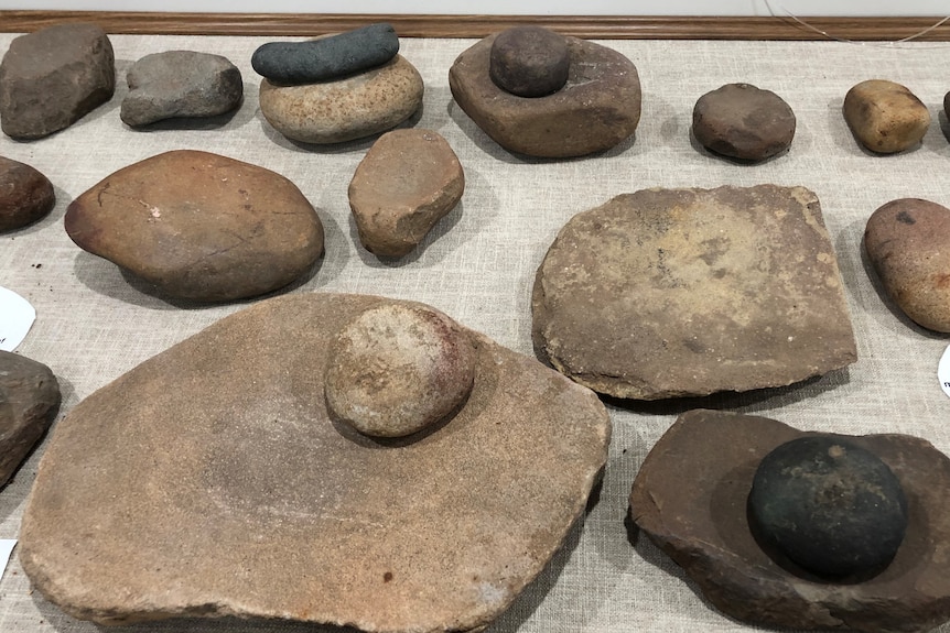 A collection of grinding stones sitting on a table. 