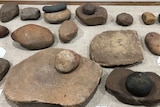 A collection of grinding stones sitting on a table. 