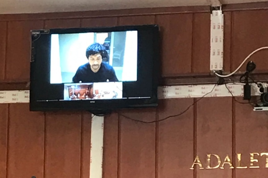 A video screen in a court room shows Neil Prakash