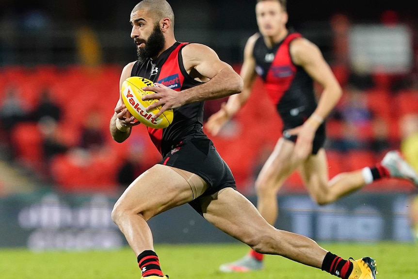 Adam Saad runs while carrying the ball, looking ahead