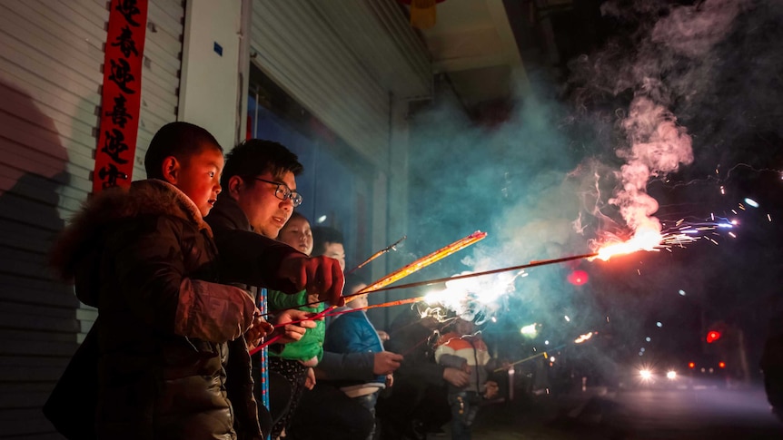 Children play with fire crackers on the eve of the Chinese Lunar New Year.