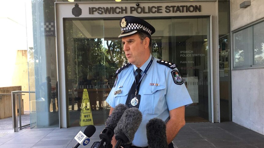 Inspector Michael Trezise speaks to the media outside the Ipswich police station.