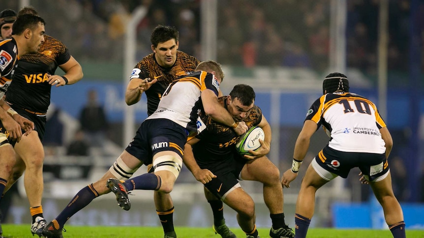 Jaguares hooker Agustin Creevy is tackled by Brumbies flanker Tom Cusack during their Super Rugby semi-final in Buenos Aires.