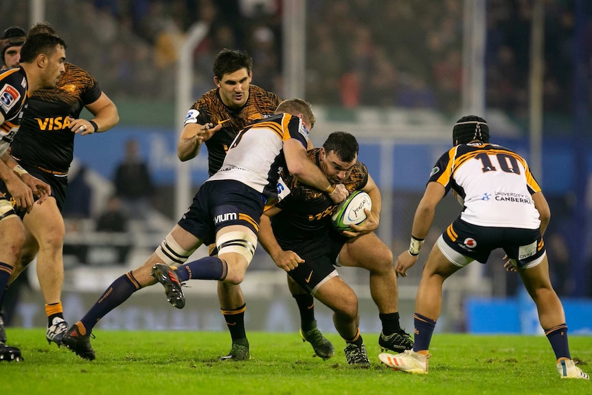 Jaguares hooker Agustin Creevy is tackled by Brumbies flanker Tom Cusack during their Super Rugby semi-final in Buenos Aires.