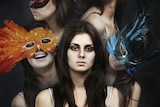 A woman wearing several masks.