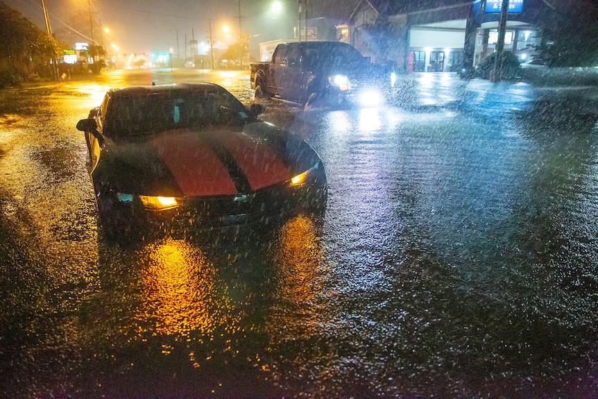 Motorists navigate a flooded Gause Boulevard in Slidell, Louisiana