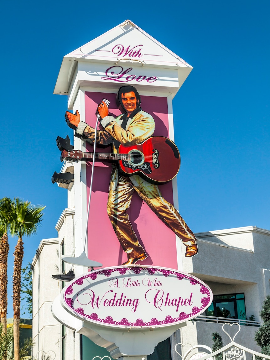 A wedding chapel sign featuring a man who resembles Elvis Presley.