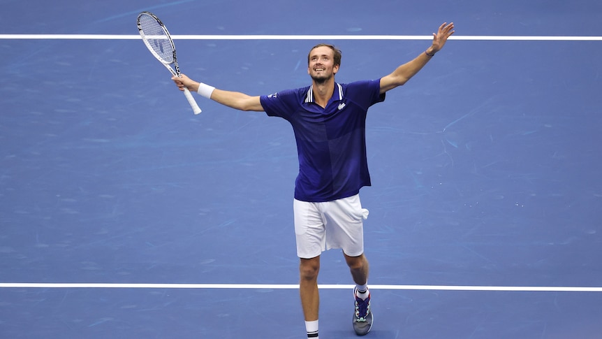 Russia's Daniil Medvedev smiles in joy and relief with his arms raised as he walks to the net after winning the US Open.