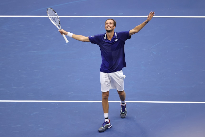 Russia's Daniil Medvedev smiles in joy and relief with his arms raised as he walks to the net after winning the US Open.