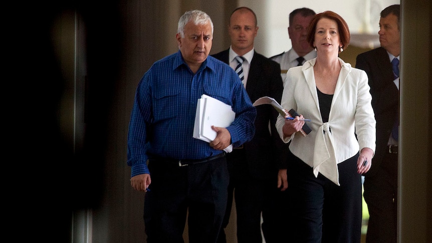 Prime Minister Julia Gillard and MP Daryl Melham arrive at the Labor caucus meeting in Canberra on February 5, 2012.