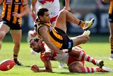 Cyril Rioli of Hawthorn and Adam Goodes of Sydney contest for the ball.
