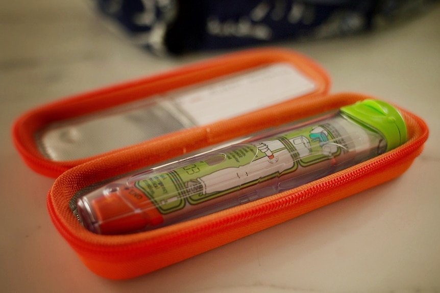 A close up of an Epipen in its case
