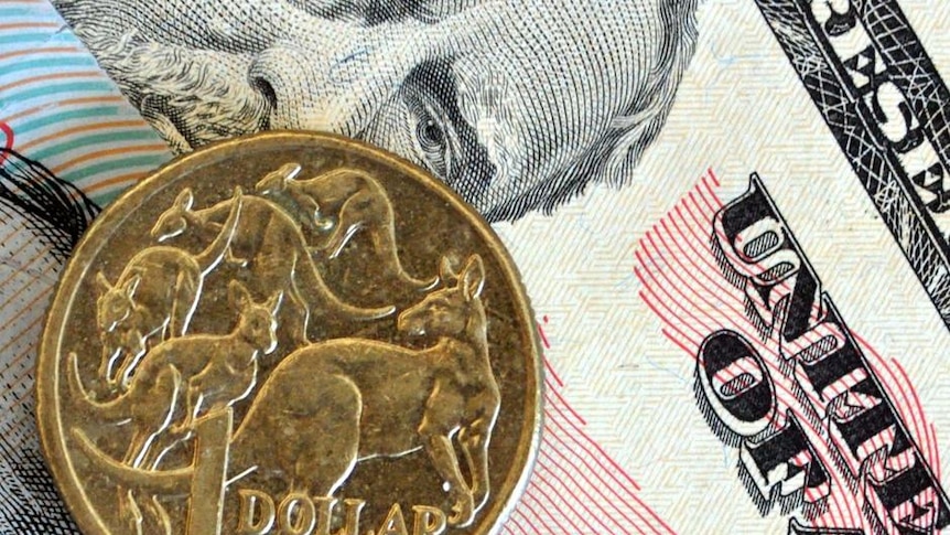 Australian and US currency are layered on a desktop