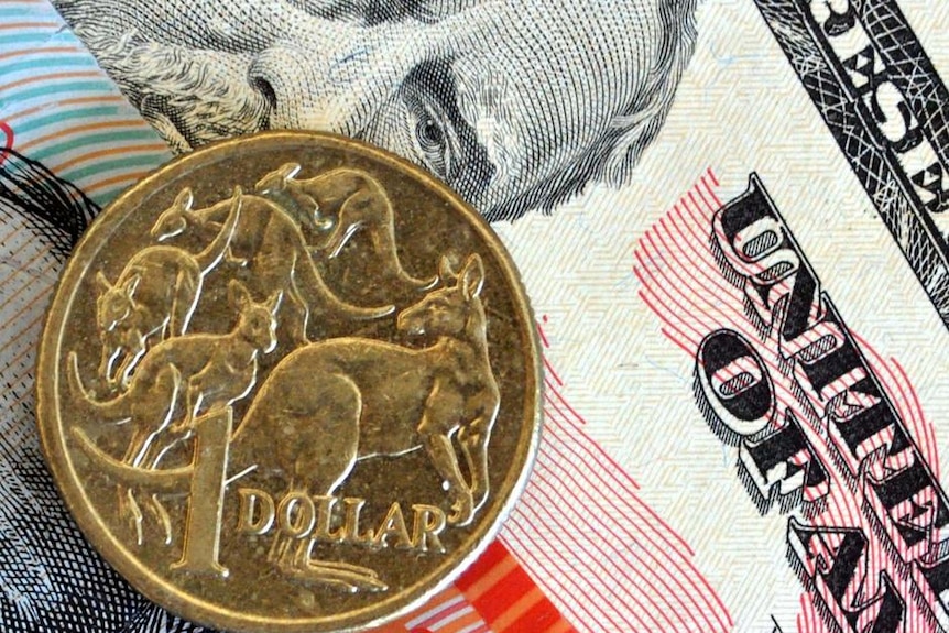 Australian and US currency are layered on a desktop.
