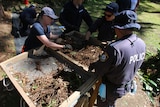 Police officers digging for evidence