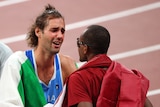 A tearful Italian high jumper talks to his rival from Qatar after they agree to share a gold medal.