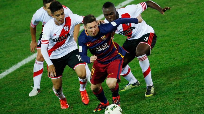 Lionel Messi takes on River Plate