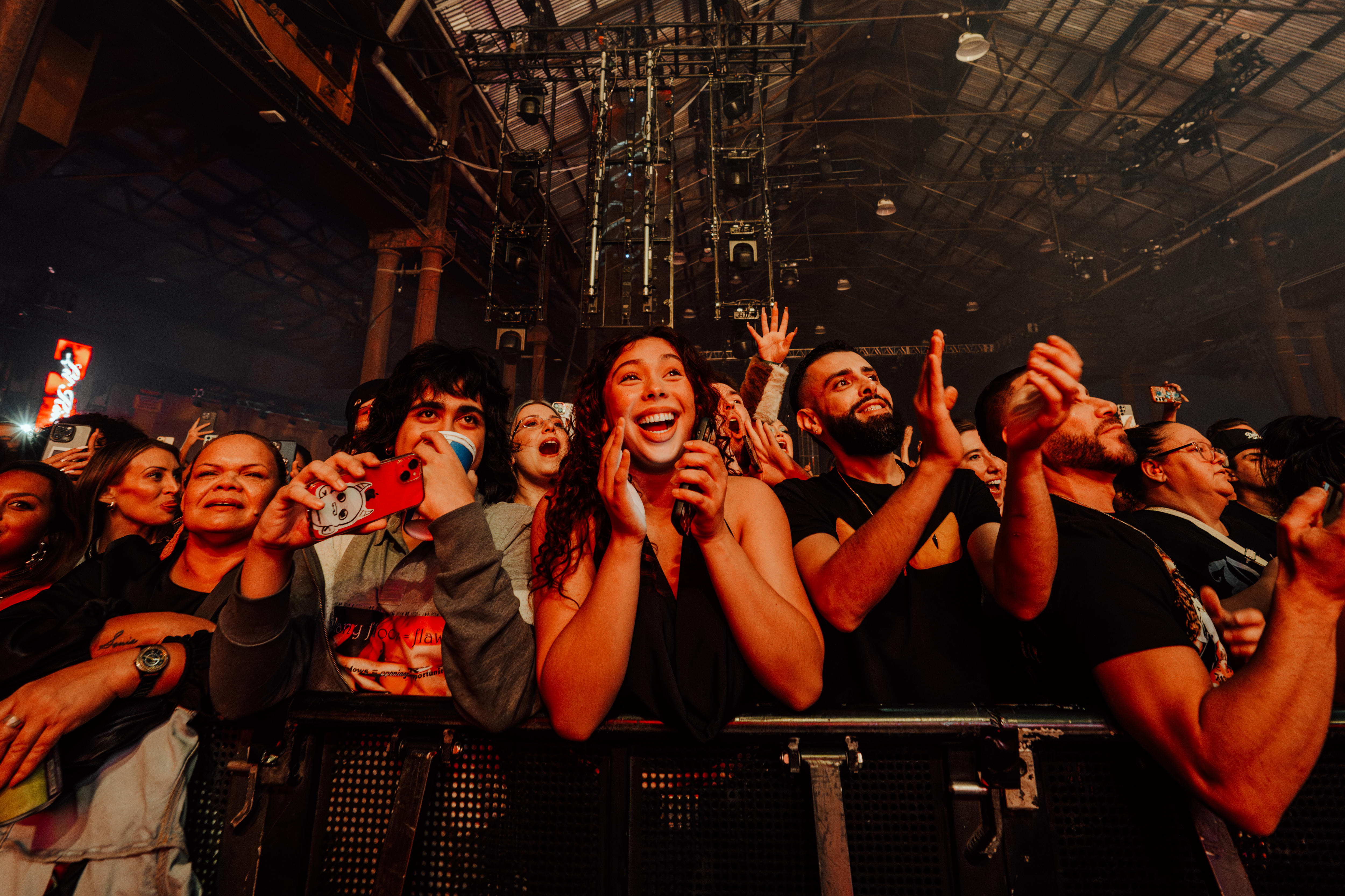 A happy audience clapping and excited to see Lil' Kim