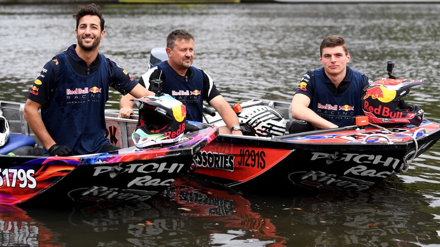 Daniel Ricciardo and Max Verstappen pose in speed boats on the Yarra River
