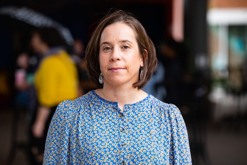 A close-up photo of Katharina Wolf wearing a blue top.