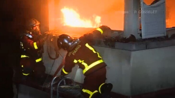 Firefighters battle the blaze in a Paris apartment.