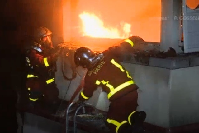 Firefighters battle the blaze in a Paris apartment.