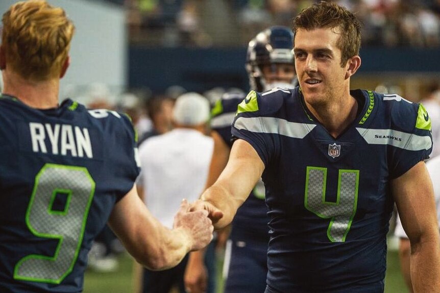 Australian rookie punter Michael Dickson shakes hands with the man he is replacing at the Seattle Seahawks, Jon Ryan.