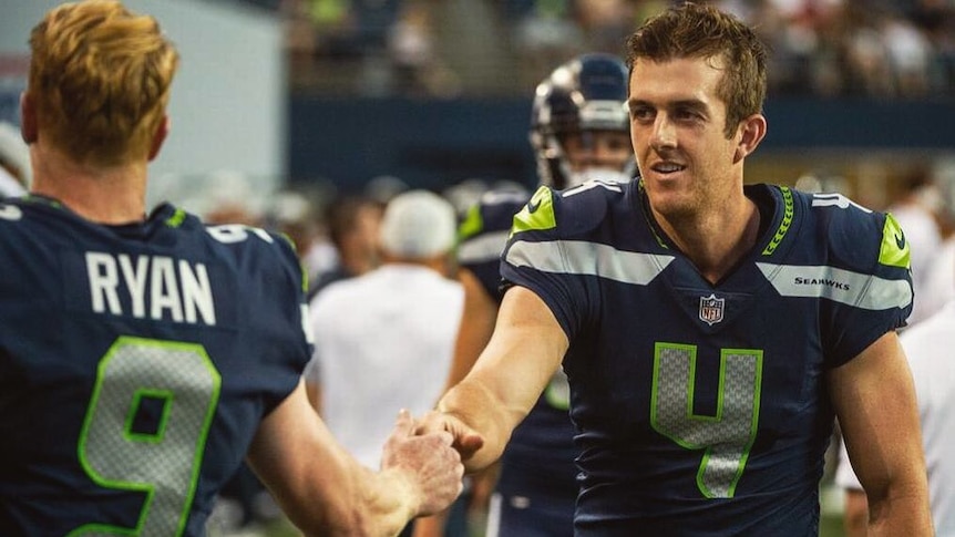Australian rookie punter Michael Dickson shakes hands with the man he is replacing at the Seattle Seahawks, Jon Ryan.