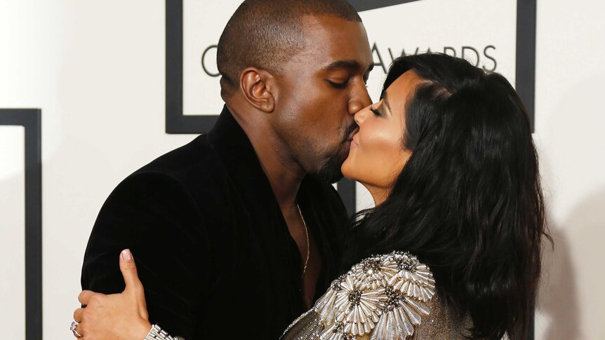 Kanye West and Kim Kardashian kiss for the cameras