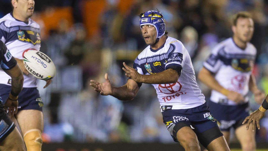 Johnathan Thurston passes the ball for the Cowboys against the Sharks.