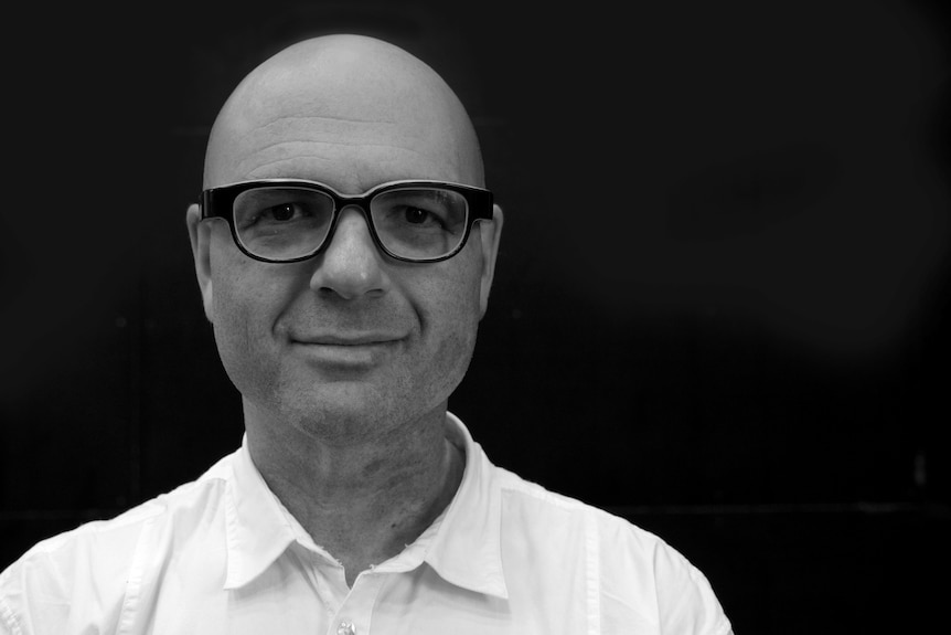 Black and white portrait of Circa artistic director Yaron Lifschitz, middle-aged man with glasses