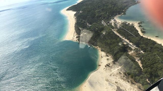 A large sinkhole on the beach spotted from the air