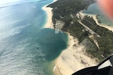 A large sinkhole on the beach spotted from the air