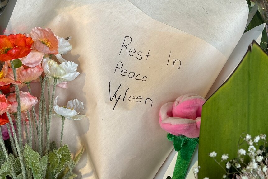 a wrapped bunch of flowers with rest in peace wvyleen written on the paper