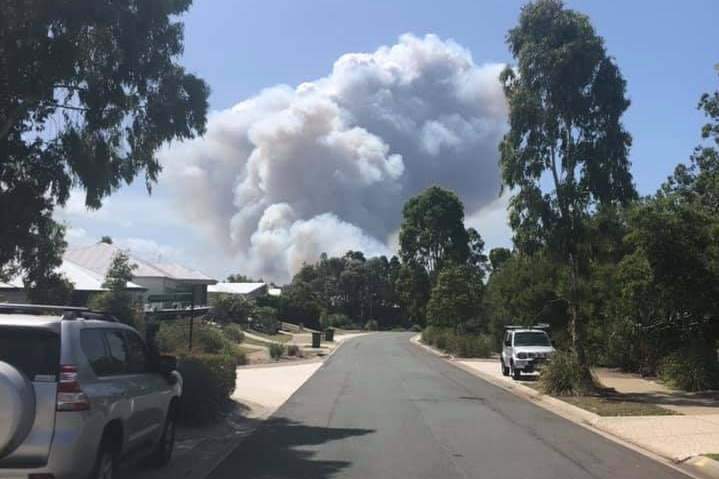 Smoke looms over a residential area.