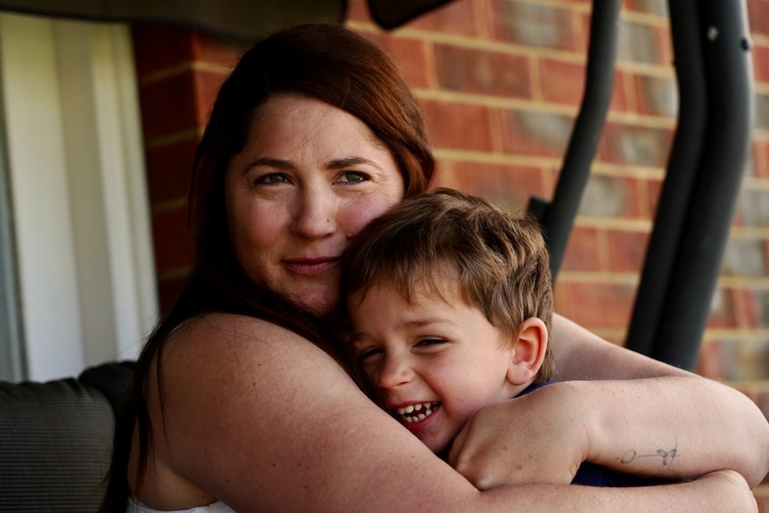 A mum hugs her young son