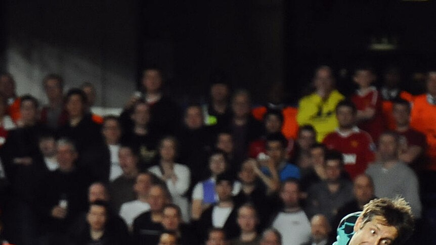 United goalkeeper Edwin Van der Sar saves from Liverpool striker Fernando Torres.