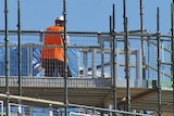 Construction worker on scaffolding on a building site, Canberra