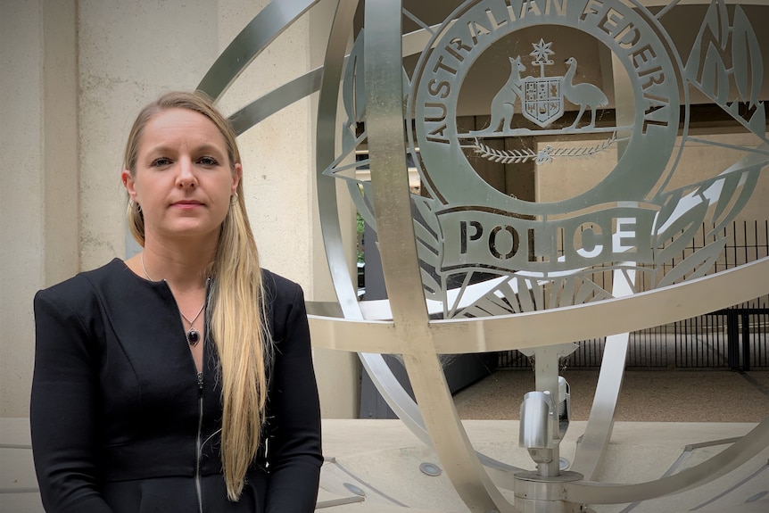 Woman wearing a black jacket standing outside the AFP in Canberra.