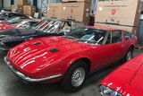 Sports cars parked in a warehouse