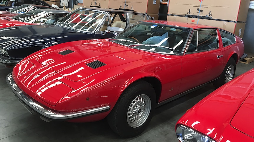 Sports cars parked in a warehouse