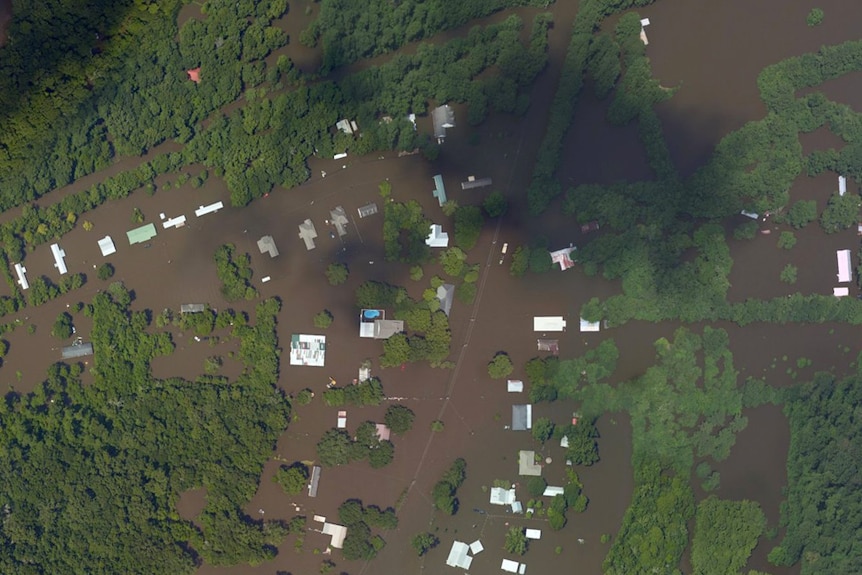 Satellite imagery shows homes and streets in Poley, Louisiana, under floodwaters.