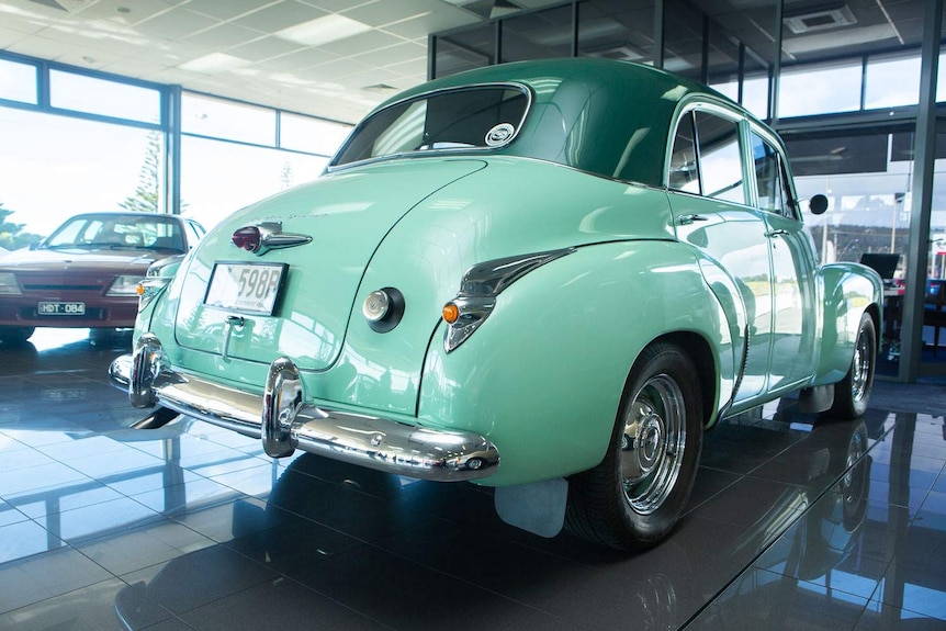 View from back of a restored FJ Holden in a car showroom
