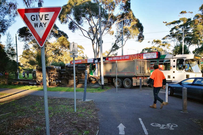 A truck lies on its side after colliding with a tram at Royal Park.