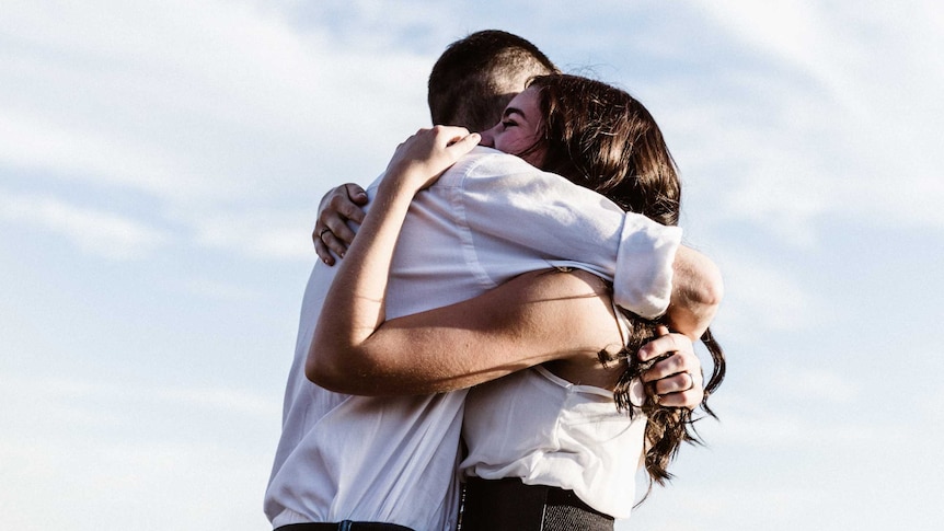 A man and woman hug