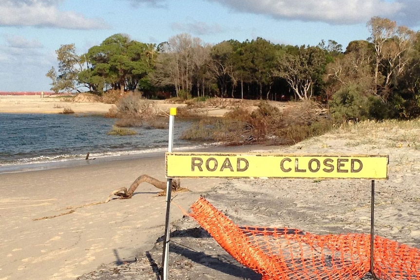 Road closed sign at near-shore landslide at Inskip Point on Queensland's Cooloola Coast